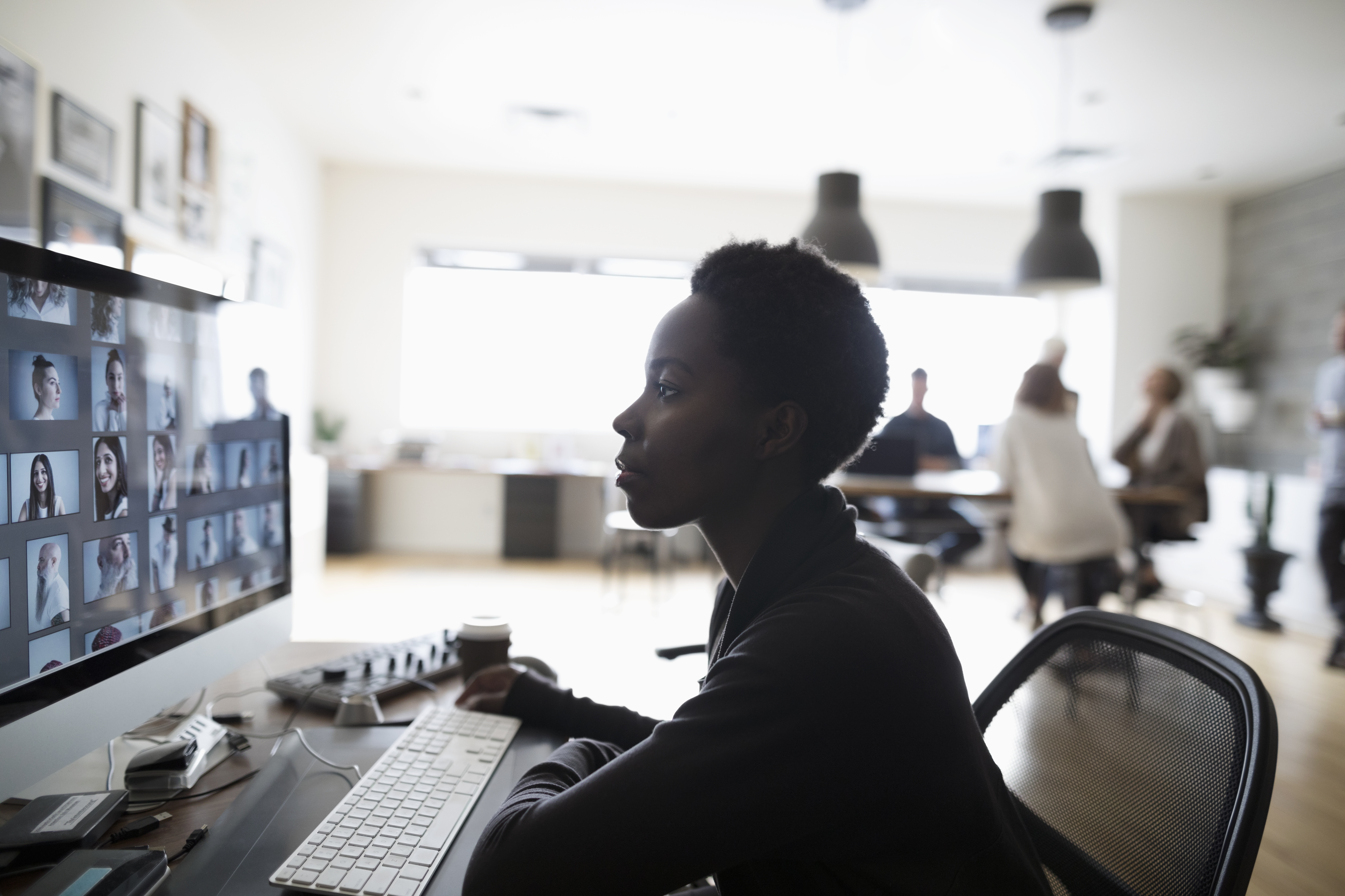 Girl editing photos in office