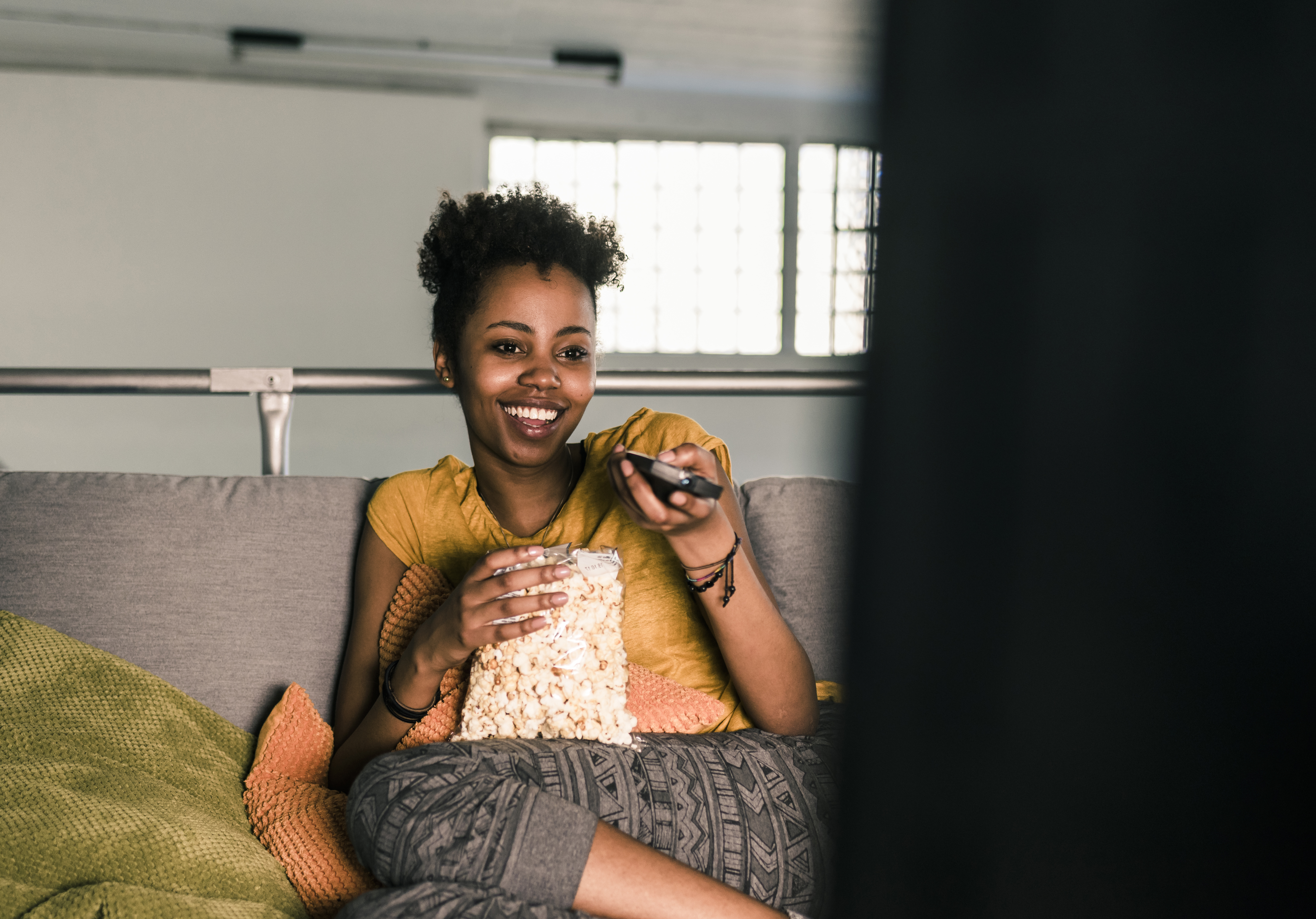Black woman watching TV